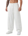 White sweatpants worn by a person on a white background